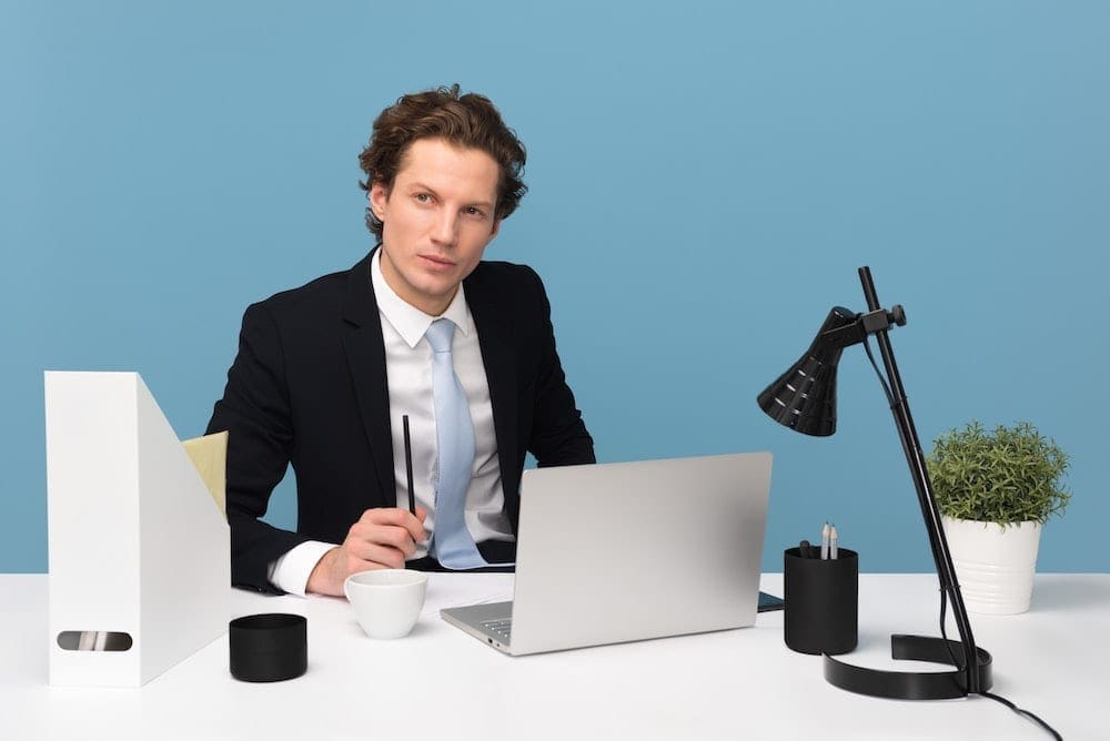 a man sitting in front of his desk