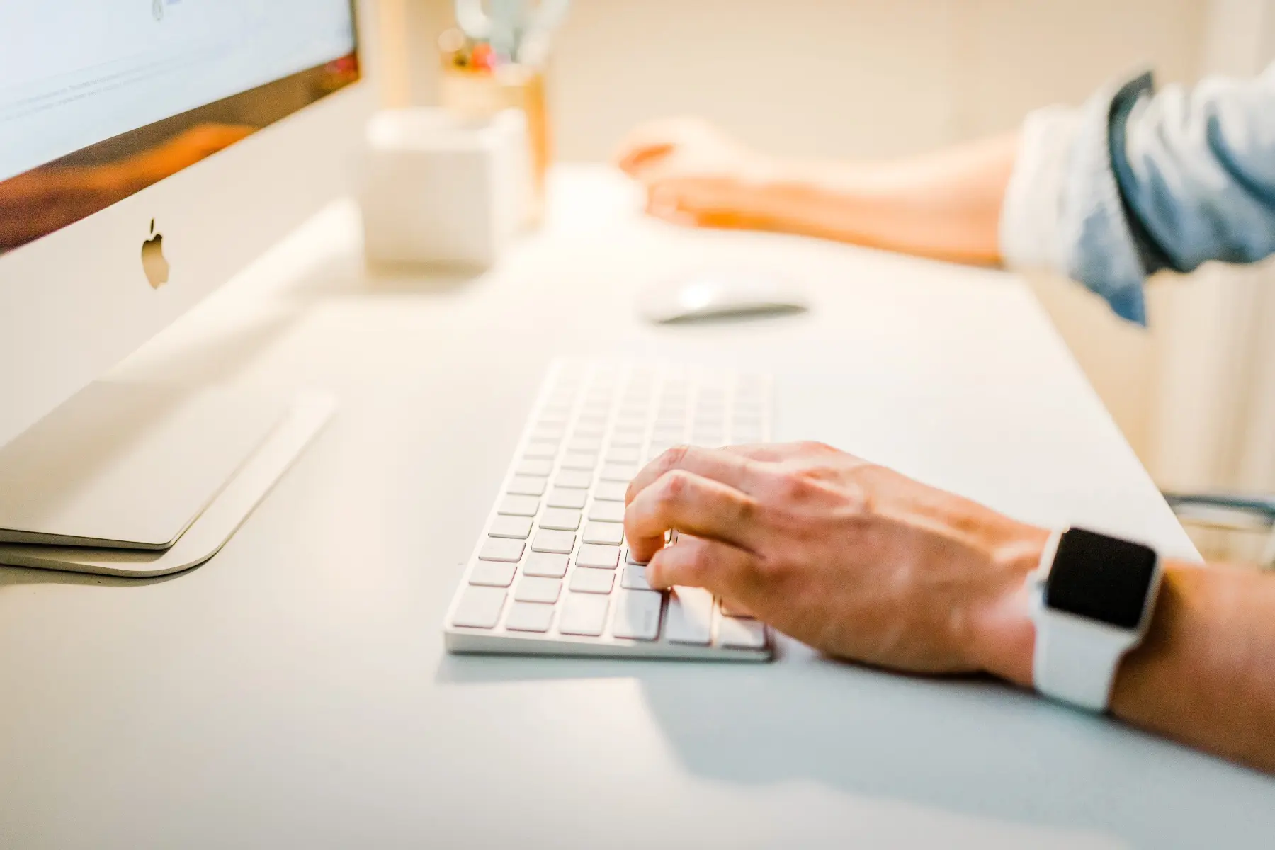 a man typing on keyboard