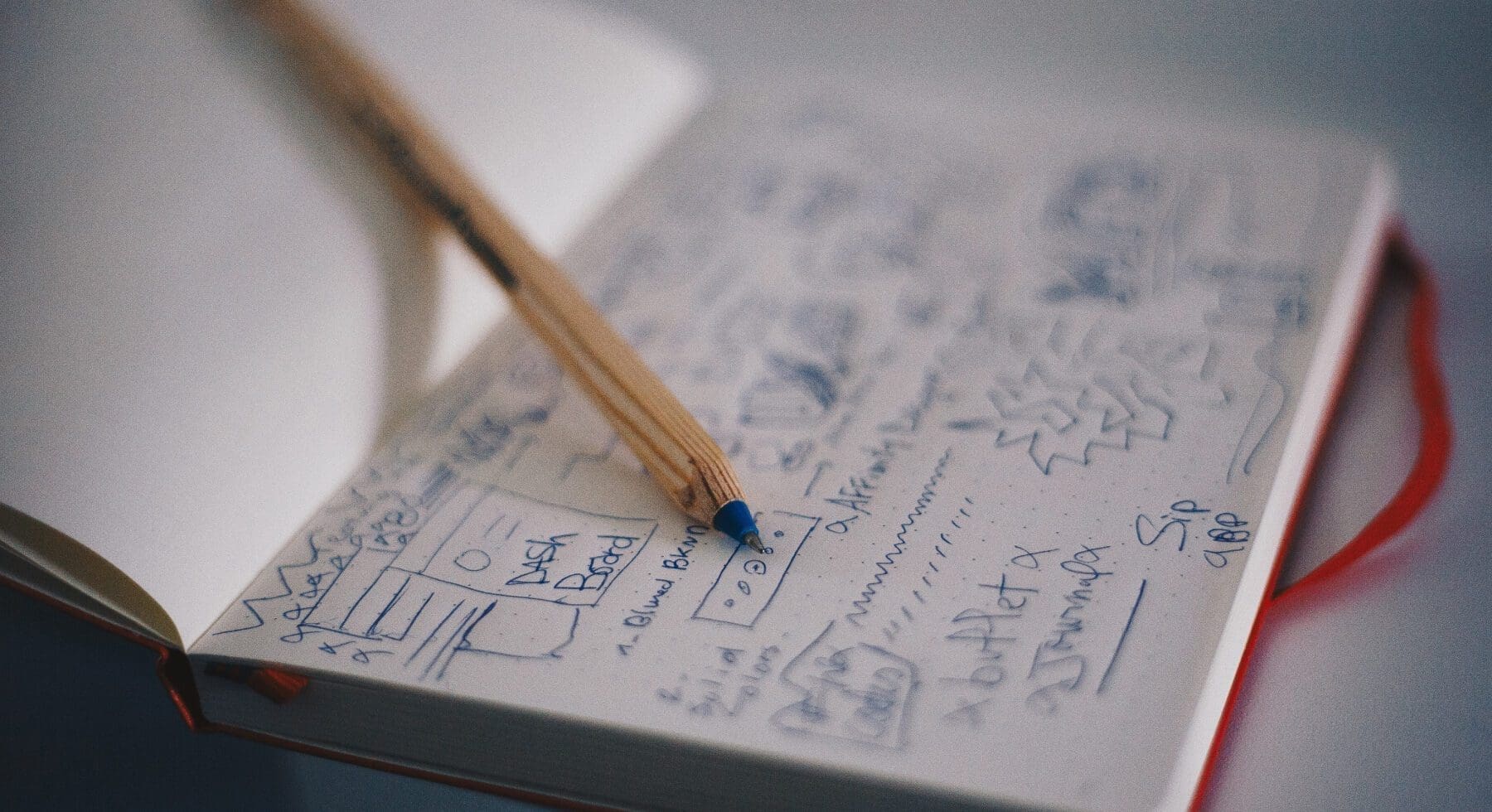 pen and notebook with scribbles