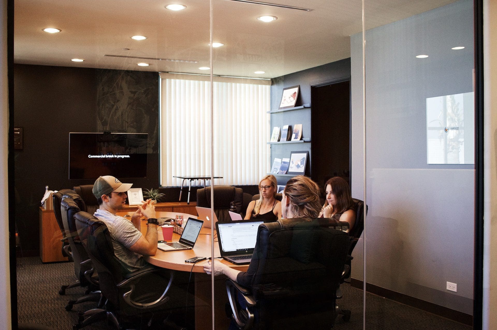 a group of people having a meeting in an office