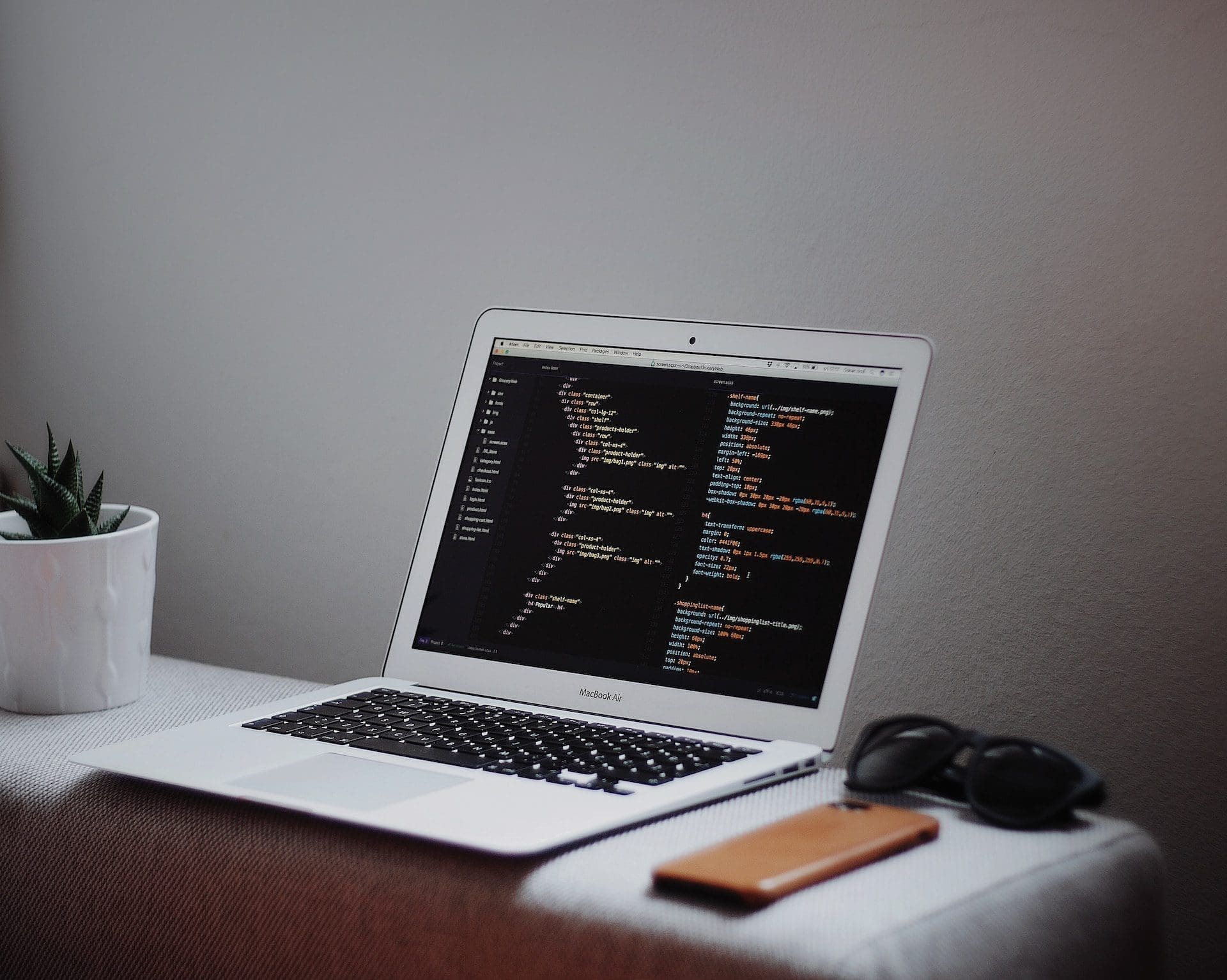 laptop with html and css on screen
