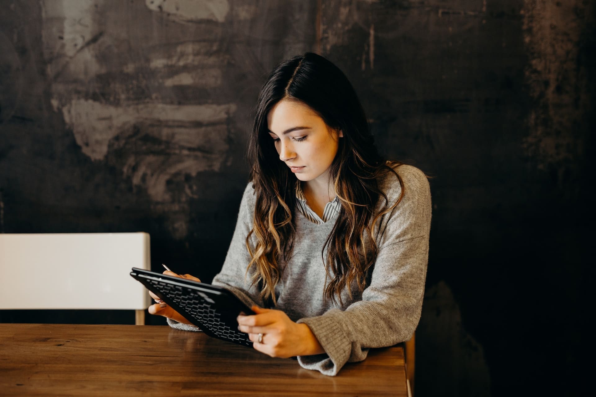 a woman holding a computer tablet
